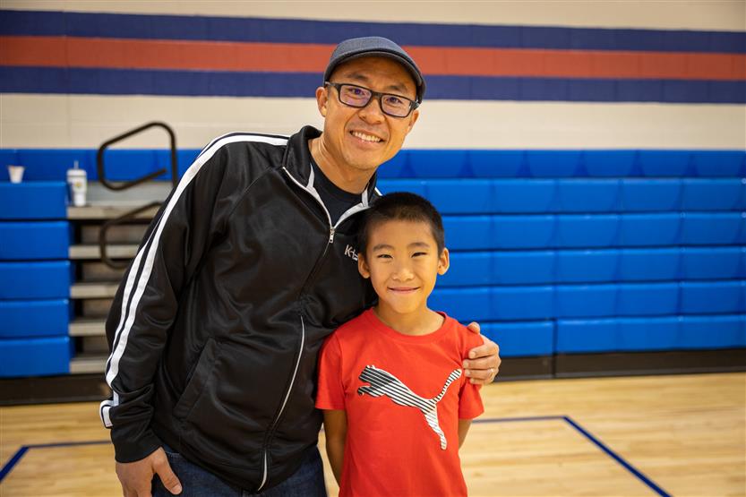 A father and son smile